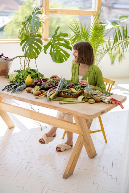 Woman with fresh healthy food ingredients indoors