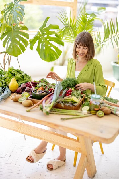 Woman with fresh healthy food ingredients indoors