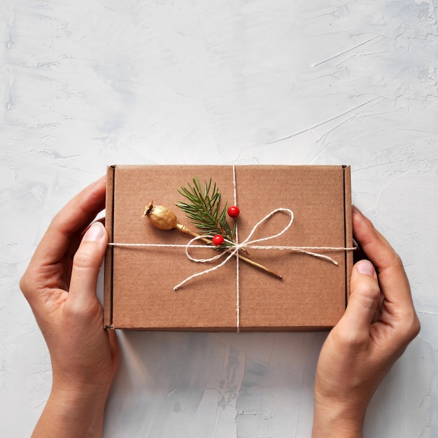 A woman with a gift box in her hand Packaging of New Year's gifts