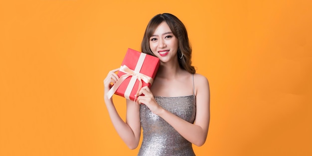 Woman with Gift Box Luxury Retro Girl in Shining silver Dress