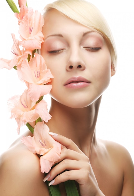 Woman with gladiolus flowers in her hands