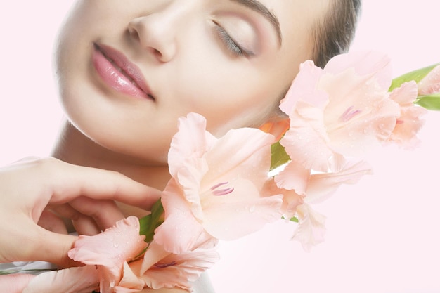 Woman with gladiolus flowers in her hands