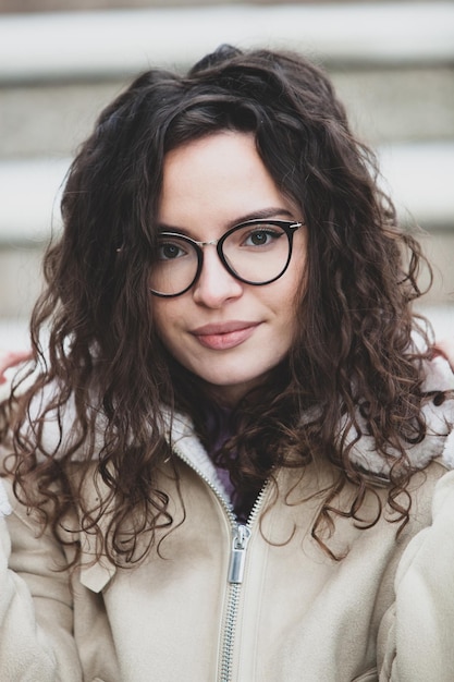 A woman with glasses and a jacket