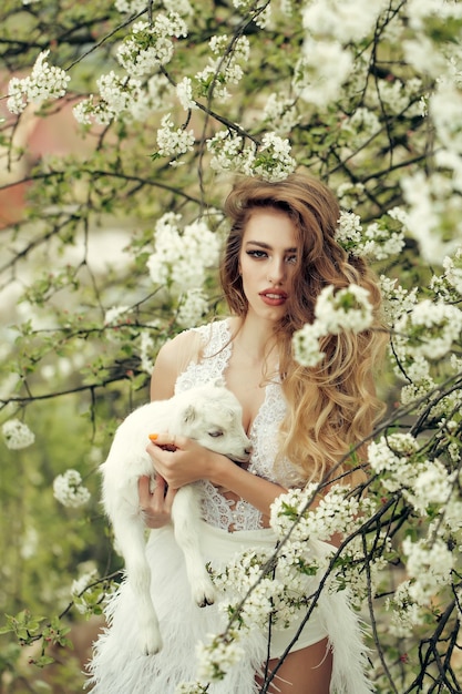 Woman with goat in blossom