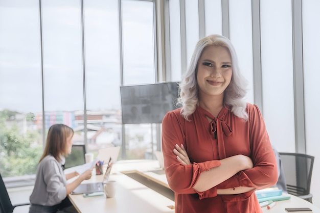 a woman with grey hair stands in front of a window with a sign that says  the word  on it