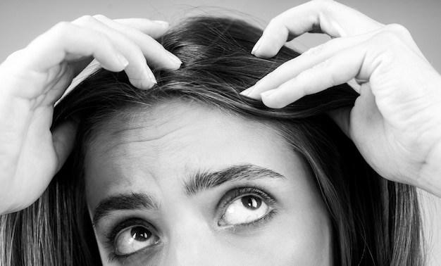 Woman with hair problem woman is looking shocked to her lost hair head bald and hair treatment concept