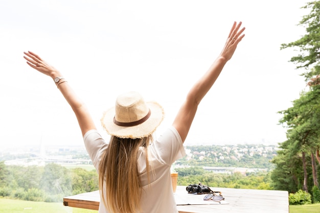 Woman with hands in the air from behind