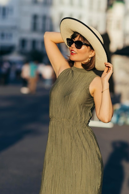 Woman with hat walking in city on a sunny day