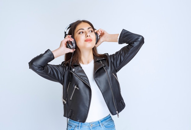 woman with headphones listening and enjoying the music.