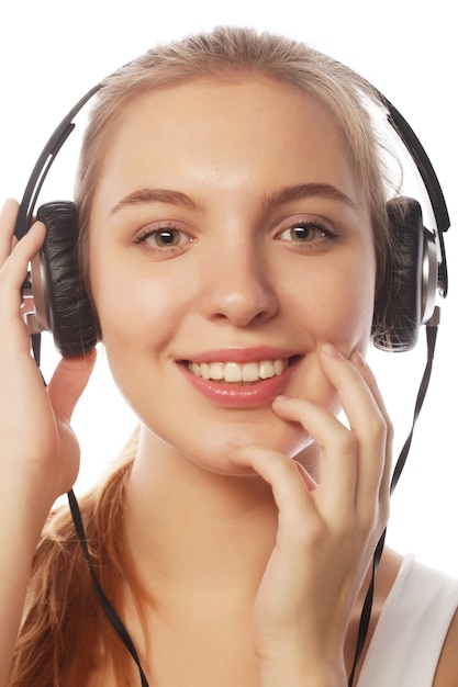 Woman with headphones listening music . Music teenager girl isolated on white.