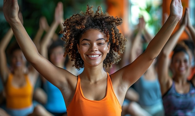 a woman with her arms raised in front of a group of people doing yoga