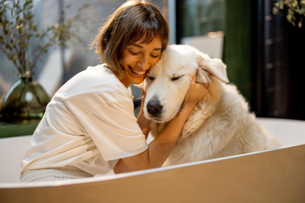 Woman with her dog in bathtub