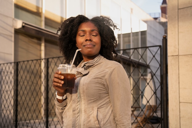 Woman with iced coffee medium shot