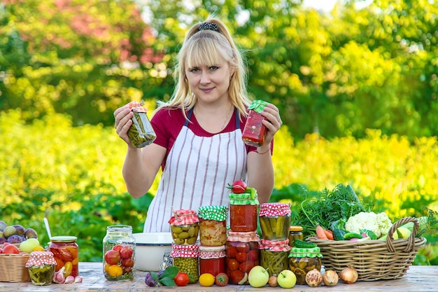 Woman with jar preserved vegetables for winter Selective focus