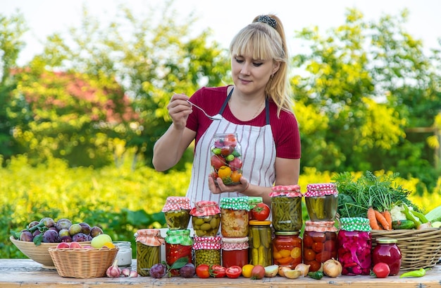 Woman with jar preserved vegetables for winter Selective focus