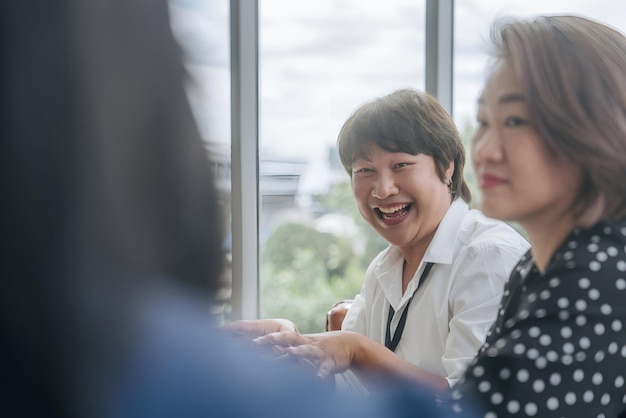 a woman with a lanyard around her neck is laughing