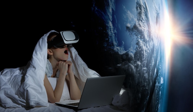 Woman with laptop enchanted by virtual reality. Mixed media