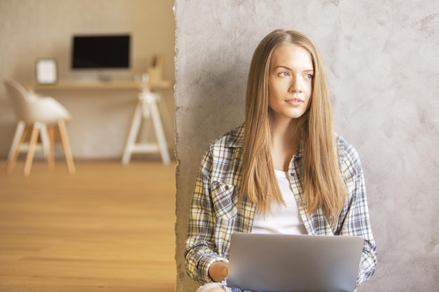 Woman with laptop on floor