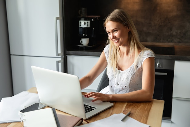 Woman with laptop working at home office. Online learning