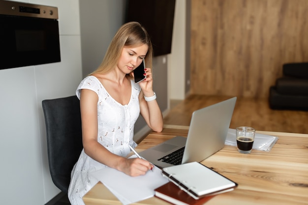 Woman with laptop working at home office