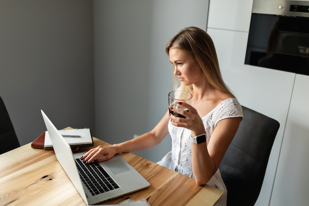 Woman with laptop working and studying at home office