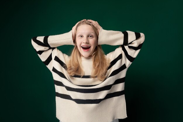 Woman with long red hair wearing striped sweater