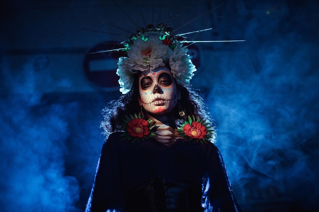 Woman with mexican skull halloween makeup on her face Day of the dead and halloween