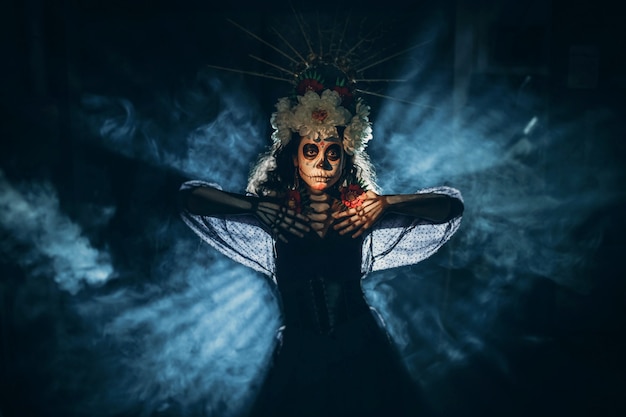 Woman with mexican skull halloween makeup on her face. Day of the dead and halloween