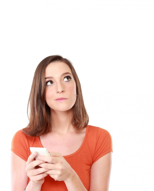 Woman with mobile phone looking up to blank space