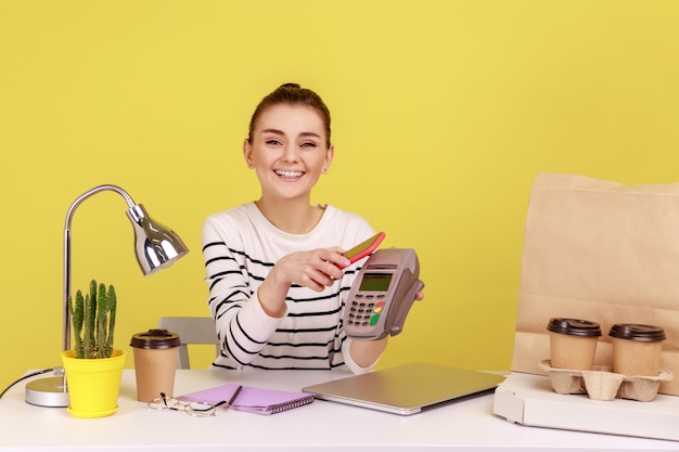 Woman with mobile smart phone and paying by pay pass pos nfc technology on cellphone and payment