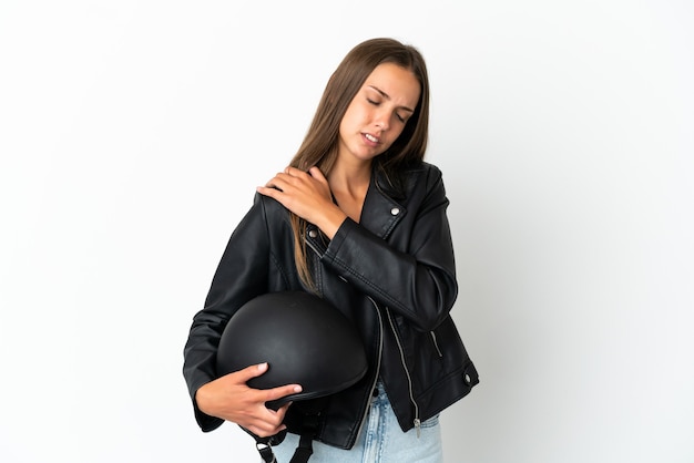 Woman with a motorcycle helmet isolated suffering from pain in shoulder for having made an effort