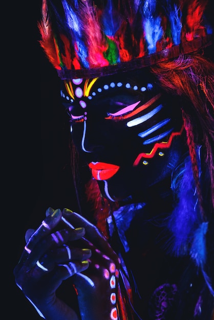 Woman with a neon makeup in ultraviolet light