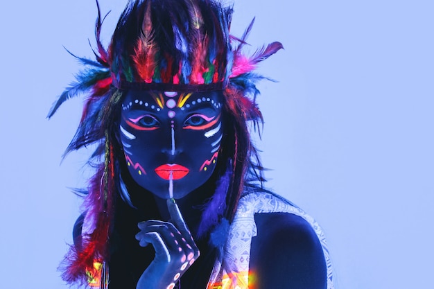 Woman with a neon makeup in ultraviolet light