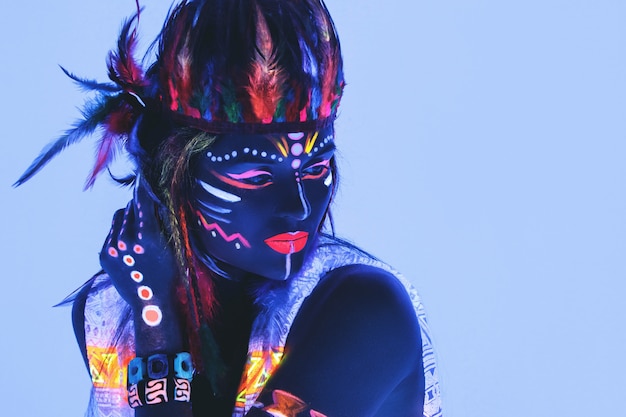 Woman with a neon makeup in ultraviolet light