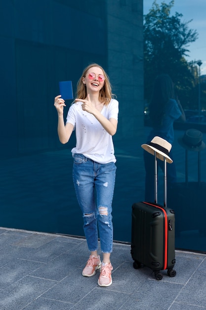 Woman with passport and luggage with glasses on holiday