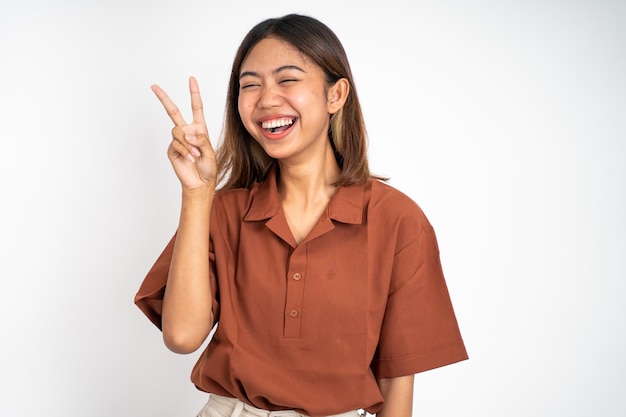 Woman with peaceful hand gesture on isolated background