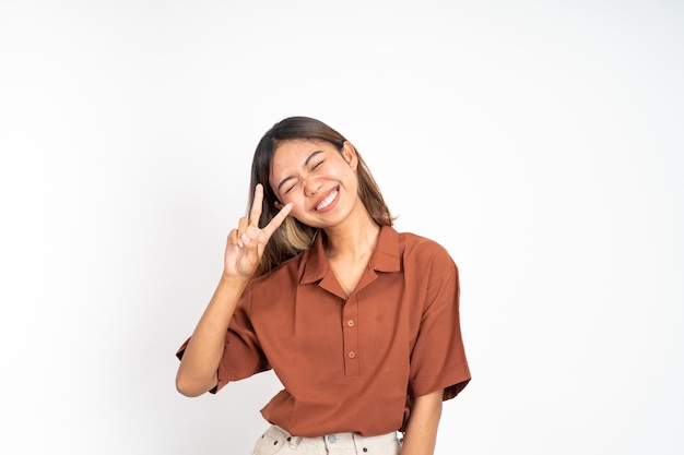 Woman with peaceful hand gesture on isolated background