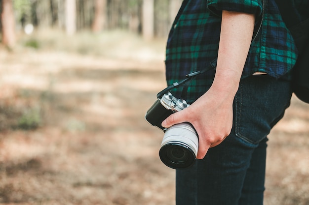 Woman with photo camera in hand Travel Lifestyle and vacation concept