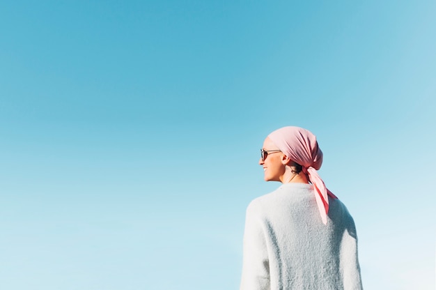 Woman with pink headscarf, has cancer