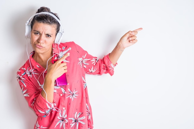 A woman with a pink phone and a pink phone in her hand pointing to the side