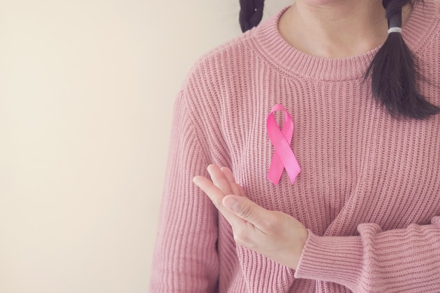 Woman with pink ribbon, breast cancer awareness. World cancer day concept