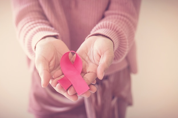 Woman with pink ribbon, breast cancer awareness, World cancer day concept