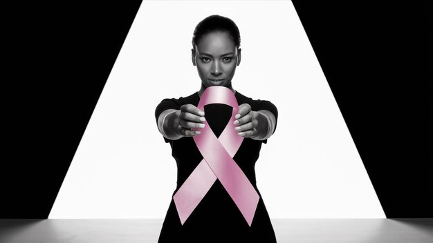 Photo a woman with a pink ribbon on her neck