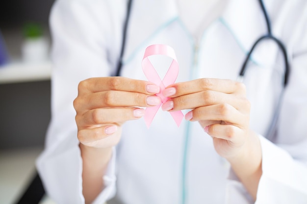 Woman with pink ribbon supporting breast cancer awareness campaign