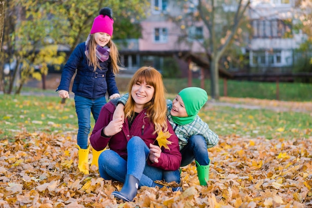 Woman with preteen children during autumn walk