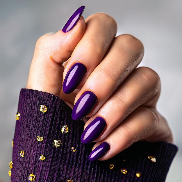 a woman with purple nails that has a purple design on the nails