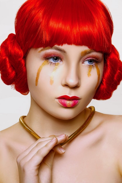 Woman with red and gold make up and red hair