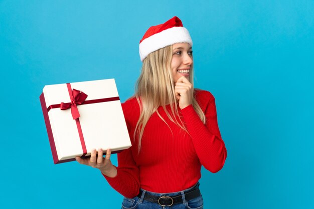 woman with santa hat holding gift box