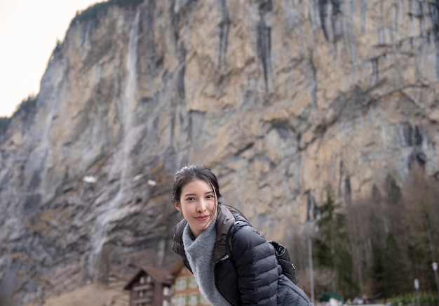 Woman with Staubbach Falls Kirche nature during winter in Lauterbrunnen Switzerland