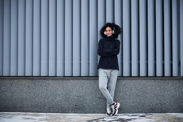 Woman with thick hair having a rest during jogging